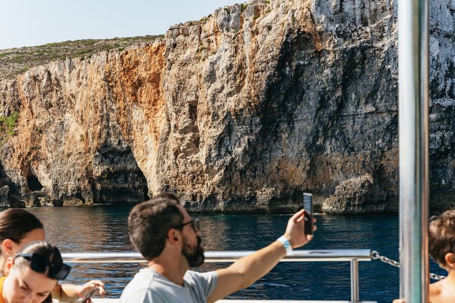 Comino: Blue Lagoon, Crystal Lagoon, and Seacaves Tour - Onboard Fun Beyond Swimming: Slide, Windows, and Lounge Time