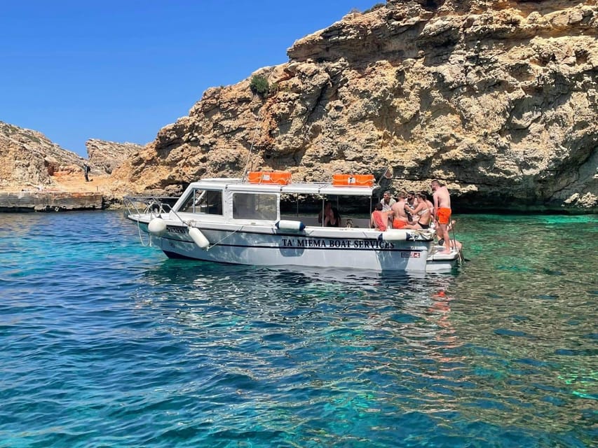 Comino: Private Boat Trips, Swimming stops and Caves Tours - Inside the Julie Pearl boat: shade, ladder access, toilet, and fresh-water rinse