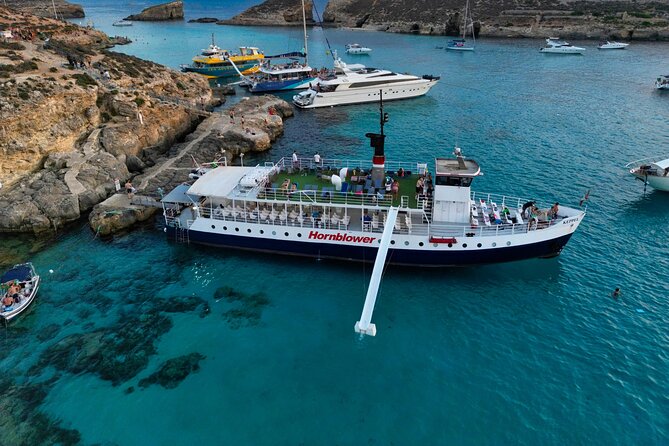 Malta Sunset Boat Tour: Bugibba to Comino Blue Lagoon Cruise - The north coast cruise: views through caves, coves, and classic photo stops